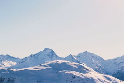 Scenic view of snowcapped mountains against clear sky
