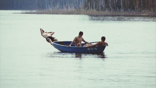 People sitting on boat in lake