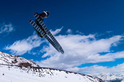 Low angle view of airplane flying against sky