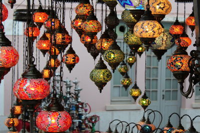 Close-up of illuminated lanterns hanging at market