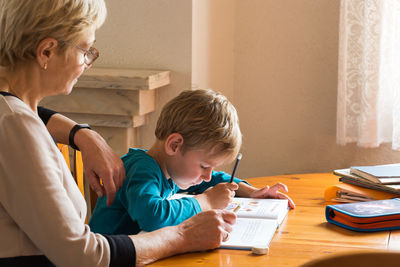 Mother and son on table