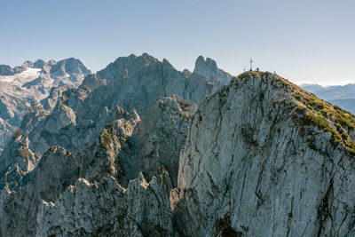 Aerial image of a group of climbers on top of mountain peak, gosaukamm, austria.