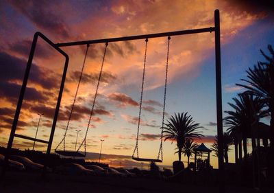 Silhouette palm trees against sky during sunset