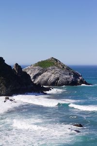 Scenic view of sea against clear blue sky