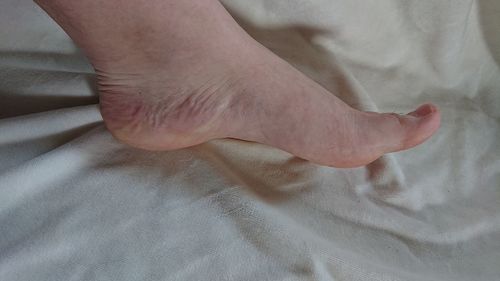 Low section of person legs on bed