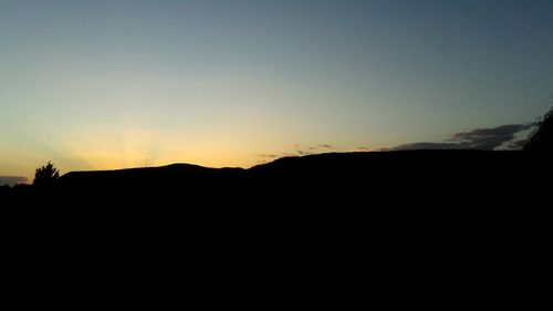 Silhouette of mountains against sky at sunset