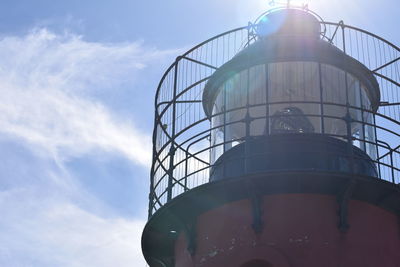 Low angle view of tower against cloudy sky