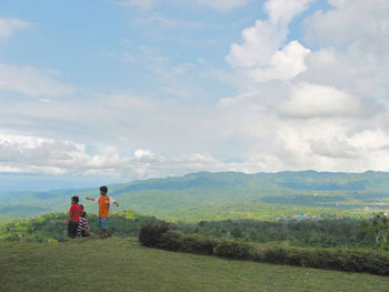 Scenic view of mountains against cloudy sky