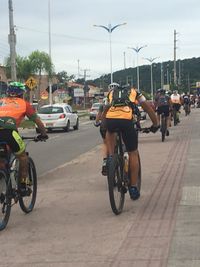 People riding bicycle on road in city