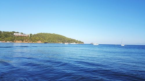 Scenic view of sea against clear blue sky