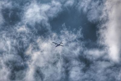 Low angle view of airplane flying in sky