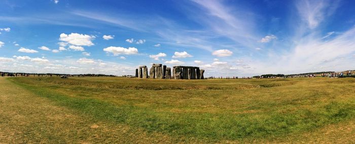 Panoramic of stonehenge on field against sky