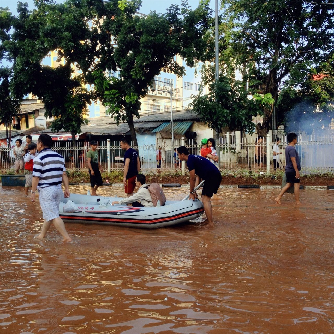 PEOPLE IN BOAT AGAINST TREES AT WATER