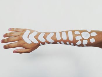 Close-up of hands over white background