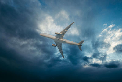 Low angle view of airplane flying in sky