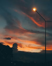 Low angle view of silhouette street against sky during sunset