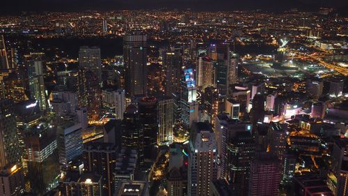 Aerial view of city lit up at night