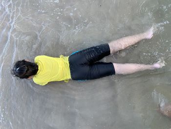 Directly above shot of girl lying on beach