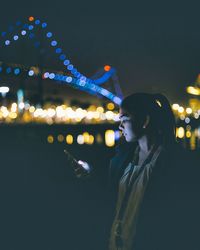 Woman with illuminated bridge