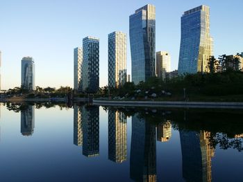 Reflection of buildings in river against sky