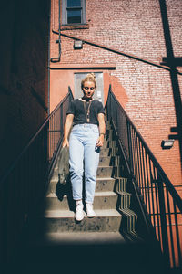 Full length portrait of man walking on stairs