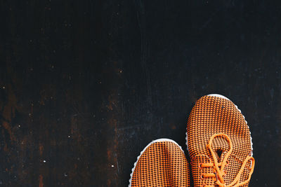 Directly above shot of orange shoes on floor