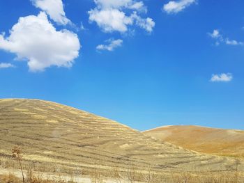 Scenic view of landscape against blue sky