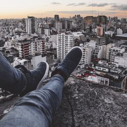 Low section of man with cityscape in background