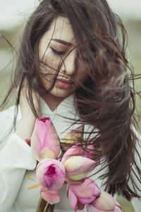 Close-up of woman with pink flowers