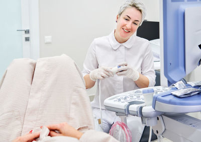 Gynecologist examining patient at hospital