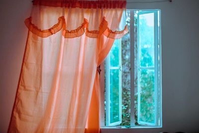 Close-up of curtain hanging on window at home