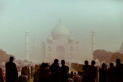 Crowd enjoying view of taj mahal during foggy weather