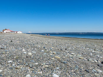 Scenic view of lighthouse and sea against clear sky