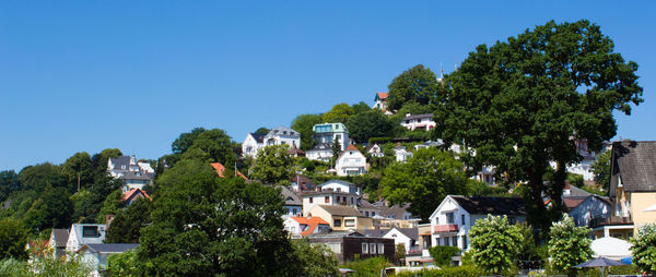 Houses in town against blue sky