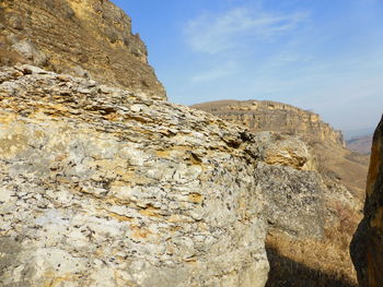 Low angle view of rock formations against sky