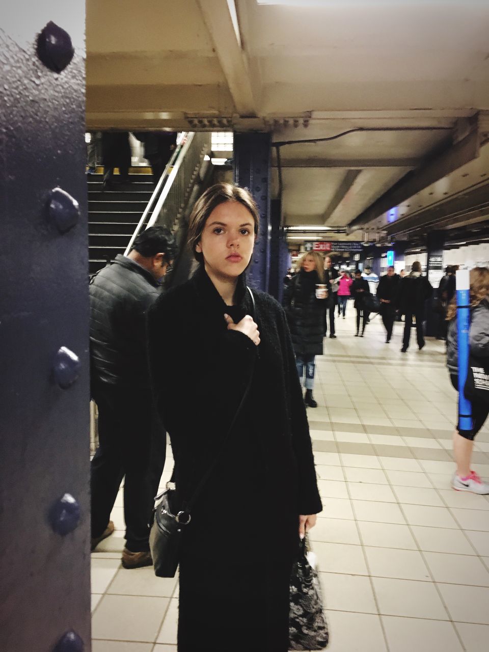 lifestyles, indoors, casual clothing, leisure activity, standing, portrait, young adult, front view, looking at camera, person, railroad station, young women, architecture, built structure, large group of people, illuminated, happiness