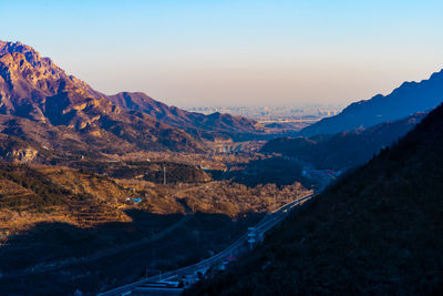 Scenic view of mountains against clear sky during sunset