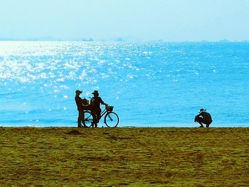 Silhouette of man riding bicycle in sea