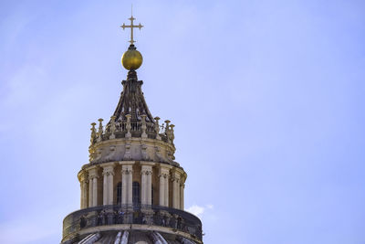 Details of the dome of saint peter basilica against a blue sky - vatican city