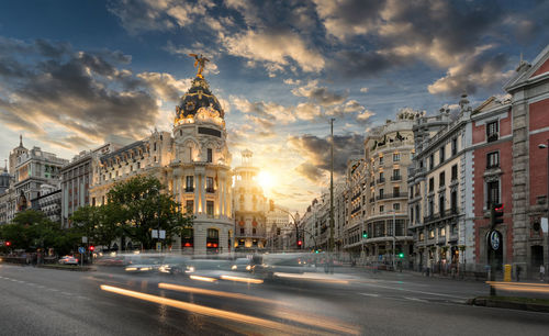 Blurred motion of cars on gran via during sunset in city