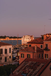 Buildings in city against clear sky