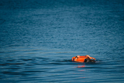 Man in boat floating on sea