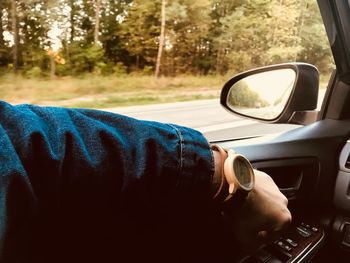 Reflection of man in car mirror