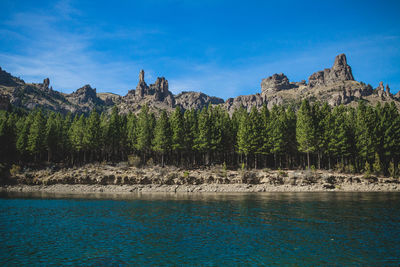 Scenic view of rocks against blue sky