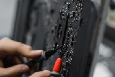 Cropped hand of man repairing car