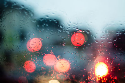 Close-up of wet glass window in rainy season