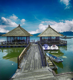 Built structure in water against blue sky