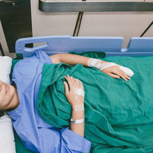 High angle view of person lying on bed