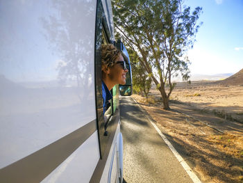 Rear view of woman walking on road