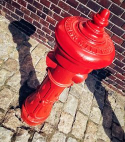 High angle view of fire hydrant on footpath